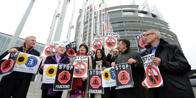 Members of the Greens/European Free Alliance group of the European Parliament hold banners reading 'stop fracking' before a v