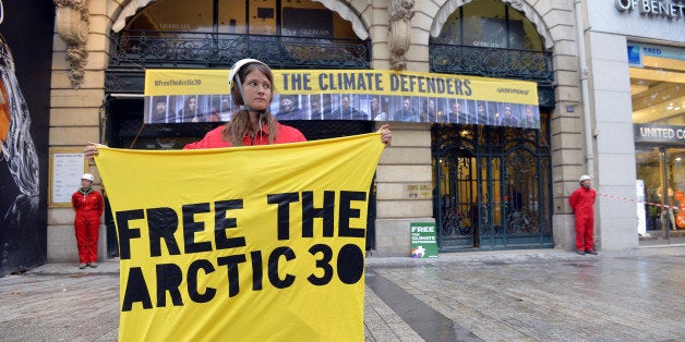 Some 10 Greenpeace activists stand in front of the Paris headquarters of the Russian company Gazprom on October 9, 2013, to demande the release of the 30 crew members of the Arctic Sunrise icebreaker imprisoned in Russia since the end of September. AFP PHOTO MIGUEL MEDINA (Photo credit should read MIGUEL MEDINA/AFP/Getty Images)