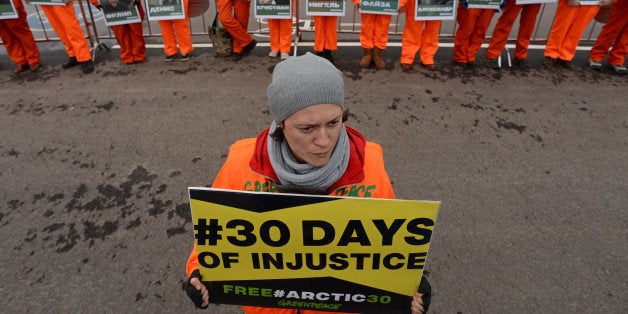 Greenpeace activists holds posters with pictures of the 'Artic 30' detained Greenpeace activists as they demonstrate in Moscow, on October 18, 2013. The the 'Arctic 30' are now in custody in Russian northern Murmansk region charged with on piracy charges for almost three weeks after their ship Arctic Sunrise was seized by Russian security forces after a protest at a Russian oil rig. AFP PHOTO / KIRILL KUDRYAVTSEV (Photo credit should read KIRILL KUDRYAVTSEV/AFP/Getty Images)