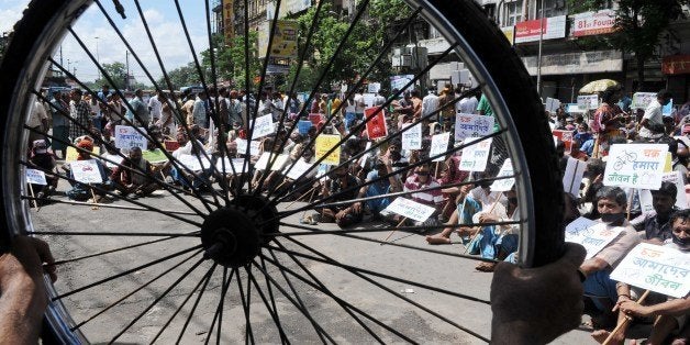 KOLKATA, INDIA - OCTOBER 2: Satyagrahis demanding return of 'Chakra' to street on Gandhi Jayanti, the occasion of 144th birth anniversary of Father of the Nation Mahatma Gandhi at Esplaned on October 2, 2013 in Kolkata, India. Kolkata police have barred bicycles and non-motorized transport from 174 thoroughfares - a blanket ban in effect. The ban impacts the poorest class who depends on these transports. Indians all over the country are celebrating the father of the nation?s birthday with prayers and social activities as a mark of respect to Gandhiji, famed as the torchbearer of India's fight against British rule. (Photo by Ashok Nath Dey/Hindustan Times via Getty Images)