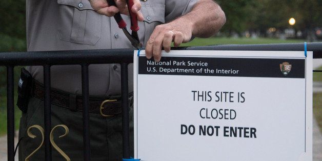 National Park Service park ranger Richard Trott removes a closed sign near the Lincoln Memorial in Washington, D.C., U.S., on Thursday, Oct. 17, 2013. After the partisan passions and heated rhetoric, the disruptions of a government shutdown and displays of dysfunction, Congress did what it could have done weeks ago: voted to fund the government and lift the debt limit. Photographer: Andrew Harrer/Bloomberg via Getty Images 