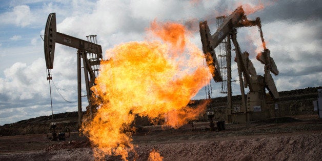 WILLISTON, ND - JULY 26: A gas flare is seen at an oil well site on July 26, 2013 outside Williston, North Dakota. Gas flares are created when excess flammable gases are released by pressure release valves during the drilling for oil and natural gas. North Dakota has been experiencing an oil boom recently, bringing tens of thousands of jobs to the region, lowering state unemployment and bringing a surplus to the state budget. (Photo by Andrew Burton/Getty Images)