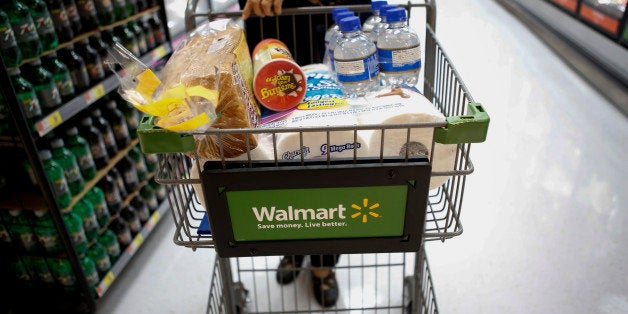 A customer pushes a shopping cart during the grand opening of a Wal-Mart Stores Inc. location in the Chinatown neighborhood of Los Angeles, California, U.S., on Thursday, Sept. 19, 2013. Wal-Mart Stores Inc. will phase out 10 chemicals it sells in favor of safer alternatives and disclose the chemicals contained in four product categories, the company announced Sept. 12. Photographer: Patrick T. Fallon/Bloomberg via Getty Images