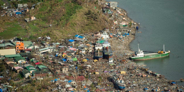 An aerial view shows the damage caused by Super Typhoon Haiyan to a seafront community nearly two weeks after the storm hit the Philippine city of Tacloban on November 21, 2013. Some 13 million people were affected by Super Typhoon Haiyan, one of the most powerful storms ever recorded, which struck the Philippine archipelago on November 8, claiming at least 4,000 lives. AFP PHOTO / ODD ANDERSEN (Photo credit should read ODD ANDERSEN/AFP/Getty Images)