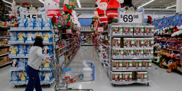 A customer shops holiday decorations for sale at a Wal-Mart Stores Inc. location ahead of Black Friday in Los Angeles, California, U.S., on Tuesday, Nov. 26, 2013. Wal-Mart Stores Inc. said Doug McMillon, head of its international business, will replace Mike Duke as chief executive officer when he retires as the world's largest retailer struggles to ignite growth at home and abroad. Photographer: Patrick T. Fallon/Bloomberg via Getty Images