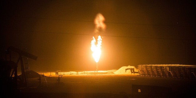 WILLISTON, ND - JULY 23: A gas flare is seen on July 23, 2013 outside Williston, North Dakota. Gas flares are created when excess flammable gases are released unexpectedly by pressure release valves during the drilling for oil and natural gas. North Dakota has been experiencing an oil boom in recent years, due in part to new drilling techniques including hydraulic fracturing and horizontal drilling. In April 2013, The United States Geological Survey released a new study estimating the Bakken formation and surrounding oil fields could yield up to 7.4 billion barrels of oil, doubling their estimate of 2008, which was stated at 3.65 billion barrels of oil. (Photo by Andrew Burton/Getty Images)