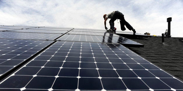 Solar installer, Justin Woodbury, Namaste (accent over the e) Solar, secures solar panels for a photovoltaic solar array system on the roof of a house in the Sorrel Ranch area, near e-470 and Smoky hill Road in Aurora Friday afternoon in record temperatures. Andy Cross, The Denver Post (Photo By Andy Cross/The Denver Post via Getty Images)