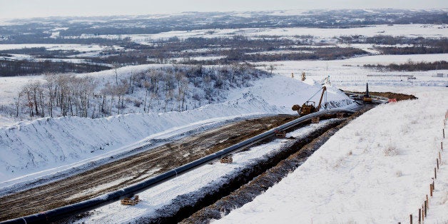 Workers continue construction on the Enbridge Inc. Athabasca Pipeline Twinning project in Hardisty, Alberta, Canada, on Saturday, Dec. 7, 2013. Canadian heavy crude reached its strongest level in more than two months on the spot market as a pipeline connection to the U.S. Gulf Coast began filling with crude ahead of its startup next month. Photographer: Brett Gundlock/Bloomberg via Getty Images