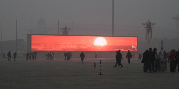 BEIJING, CHINA - JANUARY 16: (CHINA OUT) The LED screen shows the rising sun on the Tiananmen Square which is shrouded with heavy smog on January 16, 2014 in Beijing, China. Beijing Municipal Government issued a yellow smog alert this morning. (Photo by ChinaFotoPress/ChinaFotoPress via Getty Images)