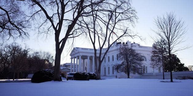 The White House is seen behind a lawn blanketed with snow on January 22, 2014 in Washington, DC. The northeastern US shivered amid heavy snowfall and far below average temperatures Wednesday in a storm that grounded thousands of flights and triggered traffic chaos. AFP PHOTO/Mandel NGAN (Photo credit should read MANDEL NGAN/AFP/Getty Images)