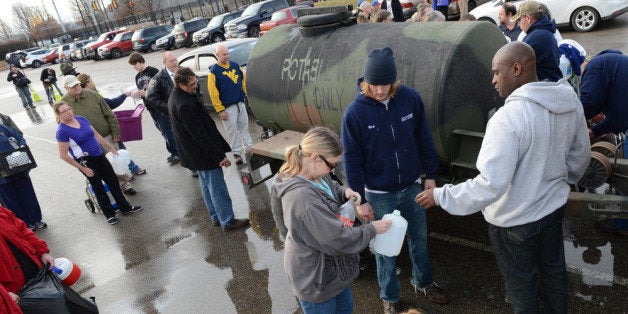 SOUTH CHARLESTON, WV - JANUARY 10: West Virginia American Water customers line up for water at the Gestamp Plant after waiting hours for a water truck, only to have it empited in about 20 minutes on January 10, 2014 in South Charleston, West Virginia. West Virginia American Water determined Thursday MCHM chemical had 'overwhelmed' the plant's capacity to keep it out of the water from a spill at Freedom Industries in Charleston. An unknown amount of the hazardous chemical contaminated the public water system for potentially 300,000 people in West Virginia. (Photo by Tom Hindman/Getty Images)