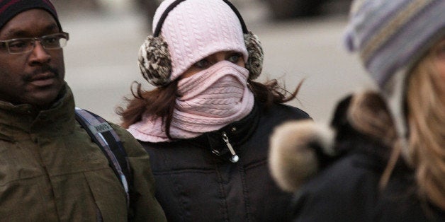 NEW YORK, NY - JANUARY 08: A woman bundles up against the cold on the afternoon of January 8, 2014 in New York City. Today was slightly warmer than yesterday, when a polar vortex descended from the Arctic on much of the country, though today's temperatures were still well below freezing. (Photo by Andrew Burton/Getty Images)