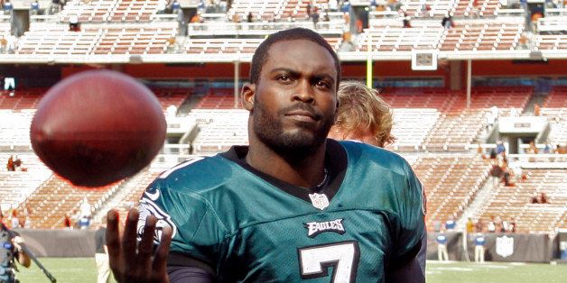 Philadelphia Eagles quarterback Michael Vick tosses a ball to a fan after a 17-16 win over the Cleveland Browns in an NFL football game on Sunday, Sept. 9, 2012, in Cleveland. (AP Photo/Ron Schwane)
