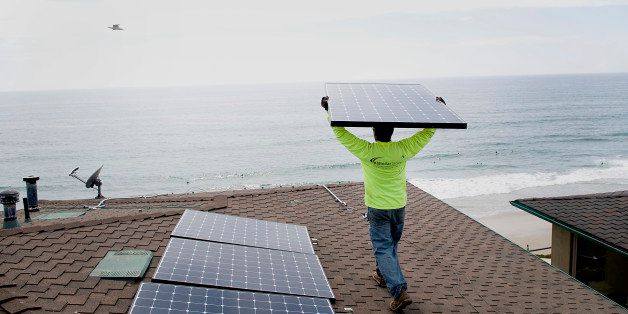 Andres Quiroz, an installer for Stellar Solar, carries a solar panel during installation at a home in Encinitas, California, U.S., on Wednesday, Aug. 15, 2012. Stellar Solar installs residential and commercial solar panels in the San Diego area. Photographer: Sam Hodgson/Bloomberg via Getty Images 