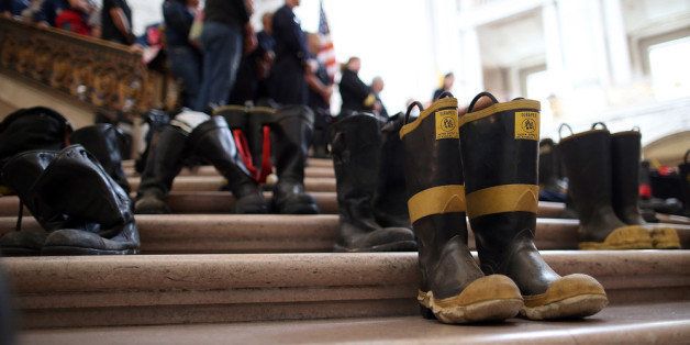 SAN FRANCISCO, CA - MARCH 26: Firefighter boots line the stairs inside San Francisco City Hall during a remembrance ceremony held for San Francisco firefighters who have died of cancer on March 26, 2014 in San Francisco, California. Over two hundred pairs of boots were displayed on the steps inside San Francisco City Hall to symbolize the 230 San Francisco firefighters who have died of cancer over the past decade. According to a study published by the National Institute for Occupational Safety and Health, (NIOSH) findings indicate a direct correlation between exposure to carcinogens like flame retardants and higher rate of cancer among firefighters. The study showed elevated rates of respiratory, digestive and urinary systems cancer and also revealed that participants in the study had high risk of mesothelioma, a cancer associated with asbestos exposure. (Photo by Justin Sullivan/Getty Images)