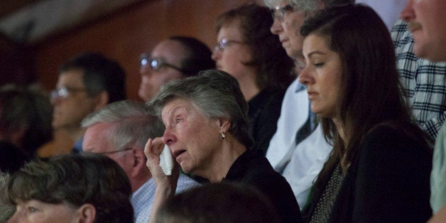 DARRINGTON, WA - APRIL 5: A woman wipes tears from her eyes during a memorial service for Linda McPherson, a beloved member of the community and a former librarian, at the Darrington Community Center on April 5, 2014 in Darrington, Washington. McPherson, 69, died in a March 22 mudslide, along with at least 29 others, and her memorial service was the first of the mudslide victims. (Photo by David Ryder/Getty Images)