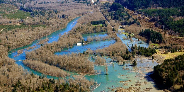 SNOHOMISH COUNTY, WASHINGTON - MARCH 23: In this handout from the Office of the Governor of Washington Jay Inslee, an aerial view of a mudslide and subsequent backup of the Stillaguamish river is seen on March 23, 2014 between Darrington and Arlington, Washington. A massive mudslide on March 22 has killed at least fourteen and left many missing. (Photo by Office of the Governor via Getty Images)