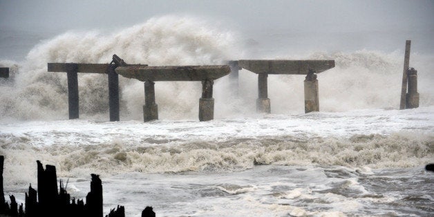 Waves crash against a previously damaged pier before landfall of Hurricane Sandy October 29, 2012 in Atlantic City, New Jerse
