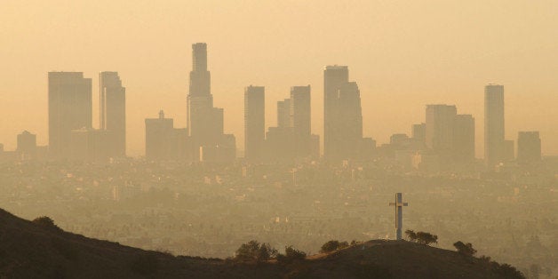 LOS ANGELES - SEPTEMBER 11: Downtown highrise buildings are shown cloaked in dirty air shortly after sunrise September 11, 2002 in Los Angeles, California. Although air quality in Los Angeles has improved in recent decades, smog levels remain among the nation's worst. Numerous wildfires in the region have also contributed to Los Angeles' air pollution problem. (Photo by David McNew/Getty Images)