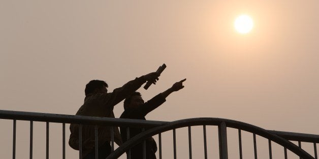 This picture taken on March 26, 2014 shows residents talking to each other on a bridge in Beijing as environmental authoritie
