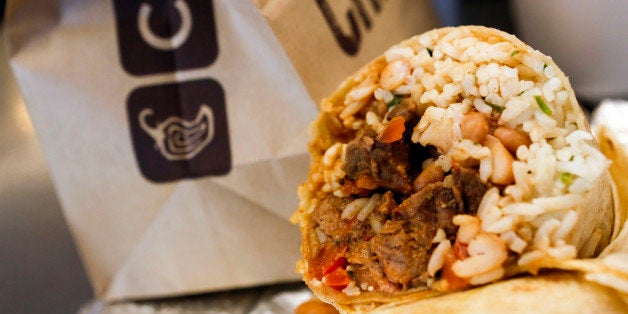 A steak burrito is arranged for a photograph with a drink and bags of chips at a Chipotle Mexican Grill Inc. restaurant in Hollywood, California, U.S., on Tuesday, July 16, 2013. Chipotle Mexican Grill Inc. is scheduled to release earnings data on July 18. Photographer: Patrick T. Fallon/Bloomberg via Getty Images