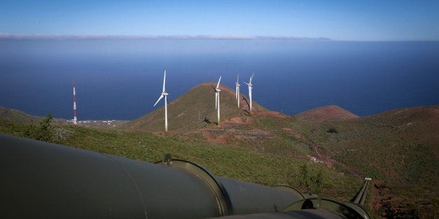 TO GO WITH AFP STORY BY KATEL ABIVEN - General view of the water pipelines and wind turbines near the upper reservoir of the Gorona power station on the Spanish Canary island of El Hierro on March 28, 2014. The smallest of the Canary Islands and least known to tourists, El Hierro is preparing to become the first island in the world generating 100% of it's electricity from renewables by combining hydo and wind power to make the island totally self sufficient. The hydro-wind power project integrates a wind farm, a pump unit and a hydroelectric plant. The wind farm is able to supply power directly to the network and simultaneously feed a group of pumping water into a higher reservoir tank as an energy storage system to be used when the wind dies dow. AFP PHOTO / DESIREE MARTIN (Photo credit should read DESIREE MARTIN/AFP/Getty Images)