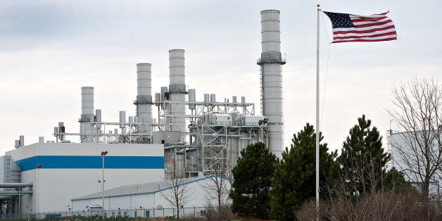 A U.S. flag flies in front of the natural gas fired 1200-megawatt Kendall Energy power plant, owned by Dynegy Inc., in Minook