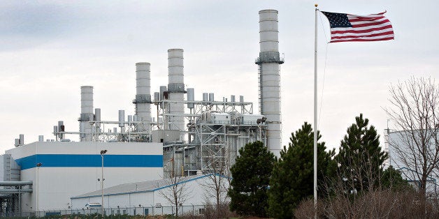 A U.S. flag flies in front of the natural gas fired 1200-megawatt Kendall Energy power plant, owned by Dynegy Inc., in Minooka, Illinois, U.S., on Sunday, Nov. 6, 2011. Dynegy Inc. and its bondholders are headed to a possible showdown in bankruptcy court after the third-largest independent U.S. power producer withdrew an offer to swap as much as $1.25 billion of notes for cash and new debt valued at 28 to 60 percent of face value. Photographer: Daniel Acker/Bloomberg via Getty Images