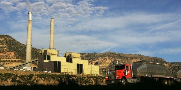 HUNTINGTON, UT - AUGUST 13: A coal truck drives along Highway 31 near the coal-powered Huntington Canyon Power Plant on the first morning of the second week of rescue efforts to reach six coal miners trapped 1,500 feet beneath the surface at the nearby Crandall Canyon coal mine August 13, 2007 in Huntington, Utah. A camera dropped through a 9-inch hole into the mine showed no signs of the miners, trapped since the August 6 cave-in. (Photo by David McNew/Getty Images)