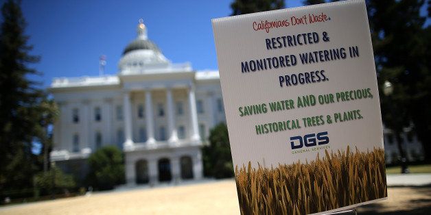 SACRAMENTO, CA - JUNE 18: A sign explaining reduced and restricted watering is posted on the dead lawn in front of the California State Capitol on June 18, 2014 in Sacramento, California. As the California drought conitnues, the grounds at the California State Capitol are under a reduced watering program and groundskeepers have let sections of the lawn die off in an effort to use less water. (Photo by Justin Sullivan/Getty Images)