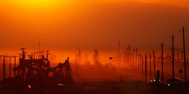 LOST HILLS, CA - MARCH 24: The sun rises over an oil field over the Monterey Shale formation where gas and oil extraction us