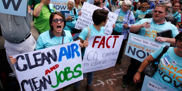 Some 300 environmental activists yell their support for stricter pollution rules proposed by the Environmental Protection Agency during a march to the William S. Moorhead Federal Building in downtown Pittsburgh by some 5000 union members, led by the United Mine Workers of America Thursday, July 31, 2014. Thursday is the first of two days of public hearings being held by the Environmental Protection Agency in Pittsburgh to discuss stricter pollution rules for coal-burning power plants proposed by the EPA. (AP Photo/Gene J. Puskar)