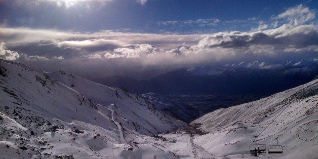 In this Thursday, July 31, 2014 photo, skiers and snowboarders enjoy clear skies at The Remarkables ski area near Queenstown,
