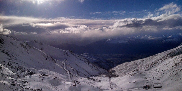 In this Thursday, July 31, 2014 photo, skiers and snowboarders enjoy clear skies at The Remarkables ski area near Queenstown, New Zealand. The Remarkables is one of several large ski areas that has been making snow at record rates following the warmest start to winter ever recorded. Scientists said New Zealand's glaciers and ice are melting at alarming rates due to climate change. (AP Photo/Richard Savoie)