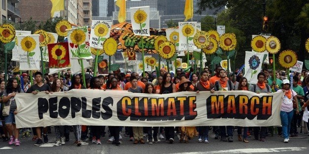 Marchers make their way across Central Park South during the People's Climate March on September 21 2014, in New York. Activists mobilized in cities across the globe Sunday for marches against climate change, with one of the biggest planned for New York, where celebrities, political leaders and tens of thousands of people were expected. The march comes before the United Nations Secretary-General Ban Ki-moon convenes a climate change summit of 120 world leaders . AFP PHOTO/Timothy A. Clary (Photo credit should read TIMOTHY A. CLARY/AFP/Getty Images)