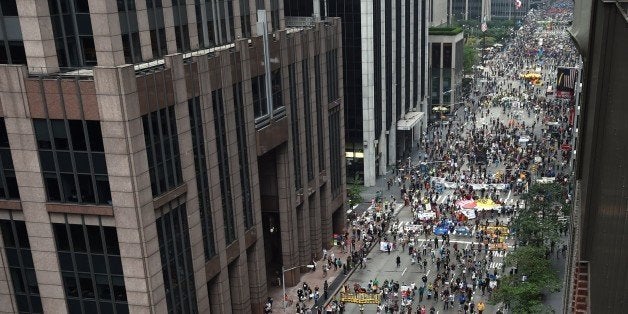 Marchers come down 6th Ave during the People's Climate March on September 21 2014, in New York. Activists mobilized in cities
