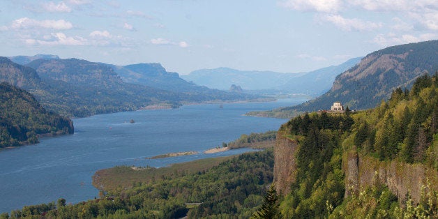 In this photo photo taken Thursday, May 12, 2011, shows the Columbia River near Corbett, Ore. The manager of most of the electricity in the Pacific Northwest is running such a surplus of power from hydroelectric dams that it put wind farms on notice Friday they may be shut down as early as this weekend. A cold, wet spring in the headwaters of the Columbia River Basin is sending downstream one of the largest spring flows in years. (AP Photo/Rick Bowmer)