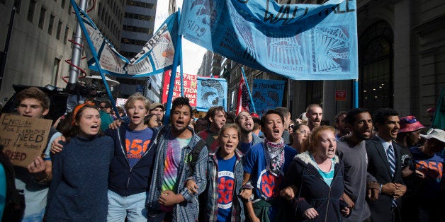 Protestors chant during a march demanding action on climate change and corporate greed, Monday, Sept. 22, 2014, a day after a huge climate march in New York. (AP Photo/John Minchillo)