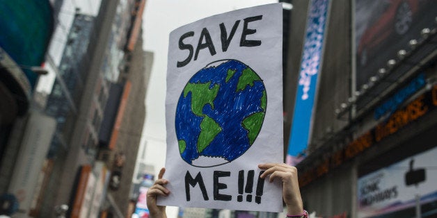 A demonstrator holds up a sign during the People's Climate March in New York, U.S., on Sunday, Sept. 21, 2014. The United Nat
