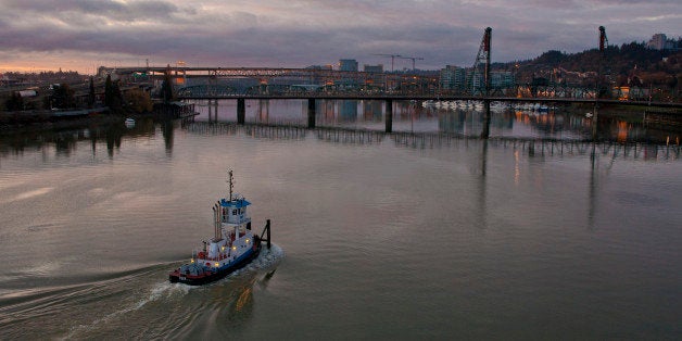 PORTLAND, OR - FEBRUARY 11: A tugboat makes its way up the Willamette River in the early morning on February 11, 2012, in Po