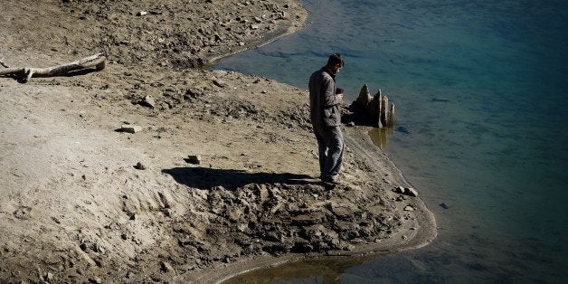 A man walks on the lake bed of Shaver lake which is at only 30 percent capacity as a severe drought continues to affect California on September 23, 2014. California is in the grip of its third year of severe drought, the worst in decades, threatening to drain underground aquifers and leaving the taps of some 40 million people to run dry. The state's drought affected Central Valley, is the considered the richest food-producing region in the world, where much of America's fresh fruits, nuts and vegetables being grown there. AFP PHOTO/Mark RALSTON (Photo credit should read MARK RALSTON/AFP/Getty Images)