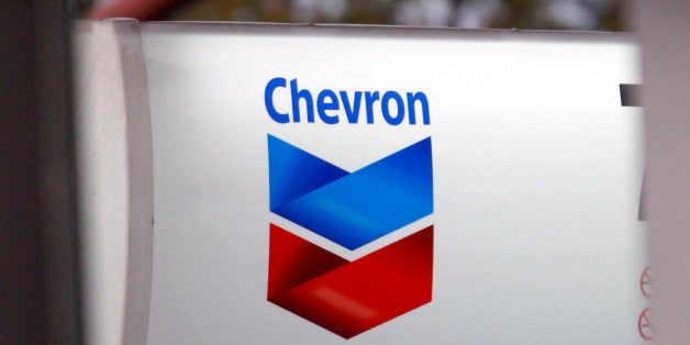 FILE - In this Oct. 29, 2009 file photo, a lit trademark sign beacons customers to the Highland Village Chevron gas station in Jackson, Miss. The Republic of Ecuador has sued the Chevron Corp. as the two battle over liability for pollution in the Amazon rainforest. The suit was filed Thursday, Dec. 3, 2009, at a federal court in Manhattan.(AP Photo/Rogelio V. Solis, file)