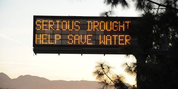 A sign over a highway in Glendale, California warns motorists to save water in response to the state's severe drought, February 14, 2014. US President Barack Obama is visiting drought-stricken California today and is expected to announce more than $160 million in federal financial aid to help California recover from the crippling drought that is threatening the state's agriculture industry. AFP PHOTO / ROBYN BECK (Photo credit should read ROBYN BECK/AFP/Getty Images)