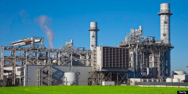 Natural gas fired turbine power plant with it's cooling towers rising into a blue sky