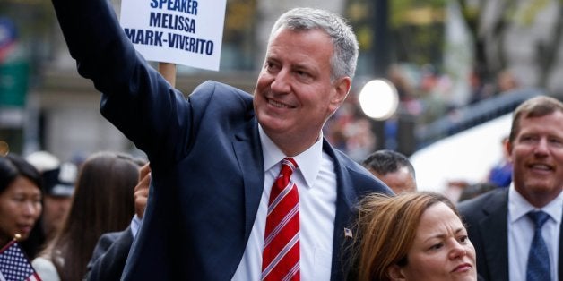 NEW YORK, NY - NOVEMBER 11: New York City Mayor Bill de Blasio (L) marches in the annual the Veteran's Day Parade along Fifth Avenue with veterans, soldiers, their families along Fifth Avenue on November 11, 2014 in New York City, United States. Often called the largest Veteran's Day Parade in the country, more than 600,000 people are expected to line the streets for the parade which celebrates the scarifies soldiers have made for the country. (Photo by Cem Ozdel/Anadolu Agency/Getty Images)