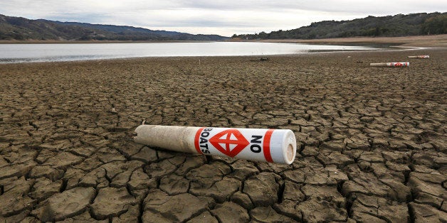 FILE -- In this Feb. 4, 2014 file photo, a warning buoy sits on the dry, cracked bed of Lake Mendocino near Ukiah, Calif. The Legislature will revisit overhauling an $11.1 billion water bond measure that is scheduled to go before voters in November, when they return from a month long summer recess. Facing one of he most severe droughts in the state's history, lawmakers are negotiating a deal that funds projects that increases water supply and availability.(AP Photo/Rich Pedroncelli, File)