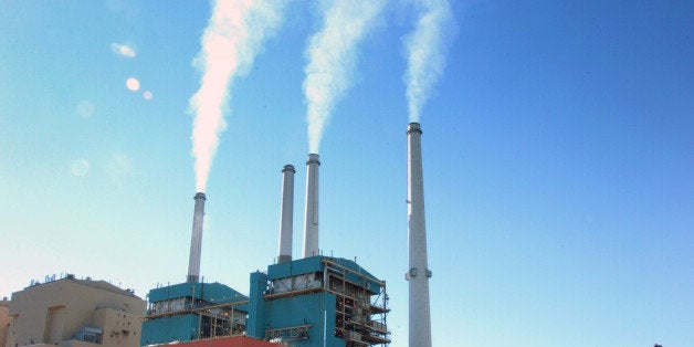 FILE - In this July 1, 2013, file photo, smoke rises from the Colstrip Steam Electric Station, a coal burning power plant in in Colstrip, Mont. State officials planned a public meeting Tuesday, Sept. 30, 2014, in Colstrip on the U.S. Environmental Protection Agency proposal to cut greenhouse emissions. The town is home to one of the largest coal-fired power plants in the West, a 2,100-megawatt facility that churns out more greenhouse gases than any other source in Montana. (AP Photo/Matthew Brown, File)