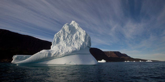 FILE - In this July 21, 2011 file photo, an iceberg floats in the sea near Qeqertarsuaq, Disko Island, Greenland. Norway is looking into providing high-speed Internet in one of the few places on Earth where it's not available: the Arctic. Demand for high-speed Internet in the Arctic is expected to grow as shipping, fishing and oil companies move north amid warming temperatures and melting ice.(AP Photo/Brennan Linsley, File)