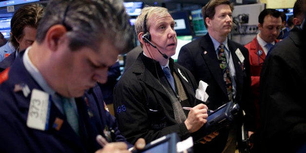 Traders work on the floor at the New York Stock Exchange in New York, Monday, April 22, 2013. Stocks edged lower on Wall Street at the start of a big week for company earnings. About a third of the companies in the S&P 500, including Exxon Mobil and Apple, are reporting earnings this week. Analysts currently expect earnings to rise by 2 percent in the first quarter, down from the 7.7 percent increase in the fourth quarter, according to S&P Capital IQ. (AP Photo/Seth Wenig)