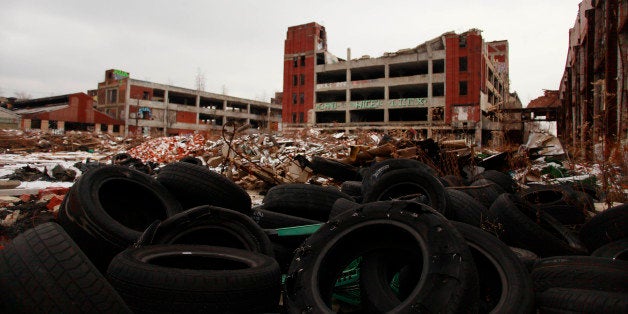 DETROIT, MI- DECEMBER 13: Old tires rest near the abandoned Packard Automotive Plant December 13, 2013 in Detroit, Michigan. Peru-based developer Fernando Palazuelo made his final payment on the Packard Plant, which he won during a Wayne County auction for $405,000. Palazuelo plans on developing the former automotive plant where luxury Packard cars were made in the coming years. (Photo by Joshua Lott/Getty Images)